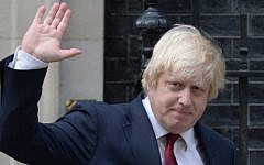 Newly appointed Foreign Secretary Boris Johnson waves as he leaves 10 Downing Street in central London on July 13, 2016 after new British Prime Minister Theresa May took office. (AFP PHOTO / OLI SCARFF)