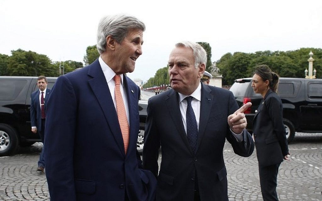 French Foreign Minister Jean-Marc Ayrault, right, welcomes US Secretary of State John Kerry before the Bastille Day Parade on the Champs Elysees avenue in Paris, on July 14, 2016.  (AFP/POOL/Thibault Camus)