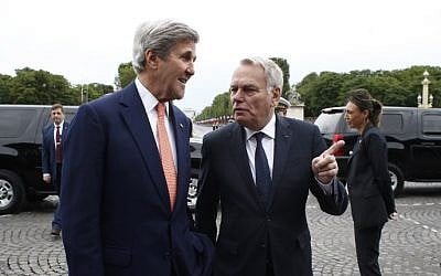 French Foreign Minister Jean-Marc Ayrault, right, welcomes US Secretary of State John Kerry before the Bastille Day Parade on the Champs Elysees avenue in Paris, on July 14, 2016. (AFP/POOL/Thibault Camus)