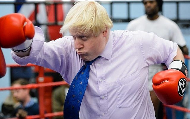 This file photo taken on October 28, 2014 shows Mayor of London Boris Johnson boxes with a trainer during his visit to Fight for Peace Academy  in North Woolwich, London, on October 28, 2014. AFP PHOTO / LEON NEAL)