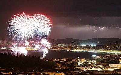 A picture taken on July 14, 2016 shows a flash of lightning as fireworks explode over the French Riviera city of Nice, southeastern France, as part of France's annual Bastille Day Celebrations. (Valery Hache/AFP)