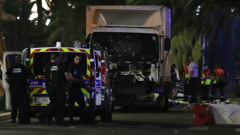 Police officers and rescue workers stand near a van that plowed into a crowd leaving a fireworks display in the French Riviera town of Nice on July 14, 2016. (Valery Hache/AFP) Police officers and rescue workers stand near a van that plowed into a crowd leaving a fireworks display in the French Riviera town of Nice on July 14, 2016. (Valery Hache/AFP)