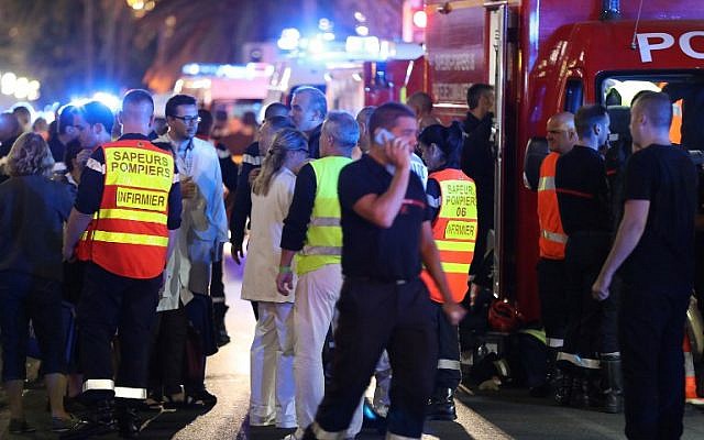 Police officers, firefighters and rescue workers are seen at the site of an attack on the Promenade des Anglais on July 15, 2016, after a truck drove into a crowd watching a fireworks display in the French Riviera town of Nice. (AFP PHOTO / Valery HACHE) Police officers, firefighters and rescue workers are seen at the site of an attack on the Promenade des Anglais on July 15, 2016, after a truck drove into a crowd watching a fireworks display in the French Riviera town of Nice. (AFP PHOTO / Valery HACHE)