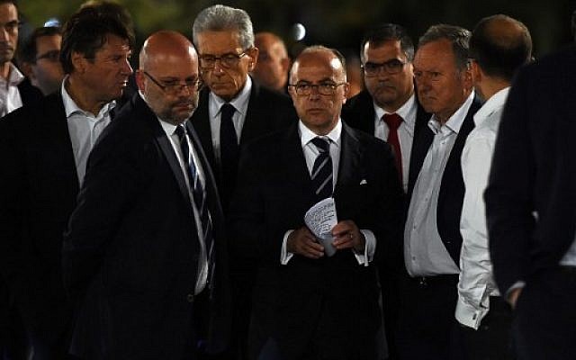 French Interior Minister Bernard Cazeneuve, center, arrives to speak to the media in Nice early on July 15, 2016 as he visits the area where a truck ploughed into a crowd of people during Bastille Day celebrations. (AFP Photo/Anne-Christine Poujoulat) French Interior Minister Bernard Cazeneuve, center, arrives to speak to the media in Nice early on July 15, 2016 as he visits the area where a truck ploughed into a crowd of people during Bastille Day celebrations. (AFP Photo/Anne-Christine Poujoulat)