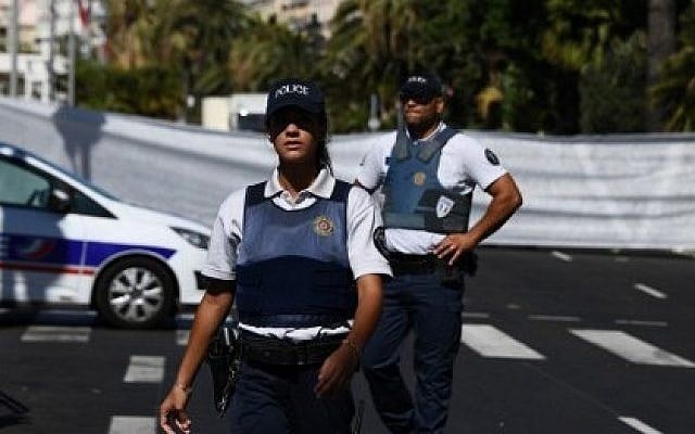 Policemen stand guard the Promenade des Anglais seafront in the French Riviera town of Nice on July 15, 2016, hours after a truck drove into a crowd watching a fireworks display. (AFP Photo/Anne-Christine Poujoulat) Policemen stand guard the Promenade des Anglais seafront in the French Riviera town of Nice on July 15, 2016, hours after a truck drove into a crowd watching a fireworks display. (AFP Photo/Anne-Christine Poujoulat)
