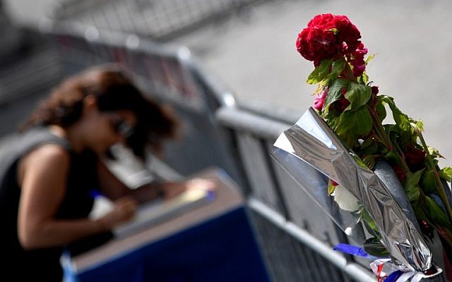 A woman signs the book of condolences in front of the French embassy in Rome on July 15, 2016, after the deadly attacks in Nice. (AFP PHOTO / TIZIANA FABI) A woman signs the book of condolences in front of the French embassy in Rome on July 15, 2016, after the deadly attacks in Nice. (AFP PHOTO / TIZIANA FABI)