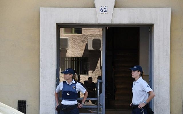 French police officers stand guard on July 15, 2016 at the entrance of a building in Nice, southern France, where the man who drove a truck into a crowd watching a fireworks display, the day before, reportedly lived.(AFP PHOTO / ANNE-CHRISTINE POUJOULAT)