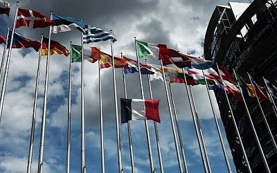 The French and European Union flags fly at half-mast in front of the European Parliament building in Strasbourg, eastern France, on July 15, 2016, the day after a gunman smashed a truck into a crowd of revellers celebrating Bastille Day in Nice, killing at least 84 people. (AFP PHOTO/FREDERICK FLORIN)