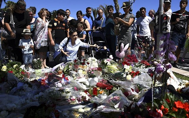 People lay flowers in the street of Nice to pay tribute to the victims the day after a gunman smashed a truck into a crowd of revellers celebrating Bastille Day, killing at least 84 people, on July 15, 2016. (AFP Photo/Anne-Christine Poujoulat) People lay flowers in the street of Nice to pay tribute to the victims the day after a gunman smashed a truck into a crowd of revellers celebrating Bastille Day, killing at least 84 people, on July 15, 2016. (AFP Photo/Anne-Christine Poujoulat)