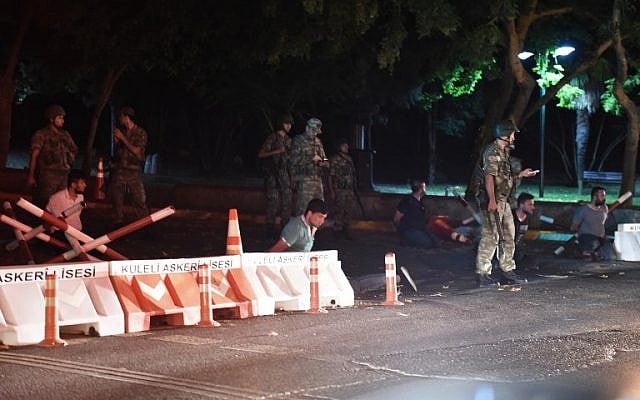 Turkish security officers detain unknown individuals on the side of the road on July 15, 2016 in Istanbul, during a security shutdown of the Bosphorus Bridge. (AFP PHOTO/BULENT KILIC) Turkish security officers detain unknown individuals on the side of the road on July 15, 2016 in Istanbul, during a security shutdown of the Bosphorus Bridge. (AFP PHOTO/BULENT KILIC)