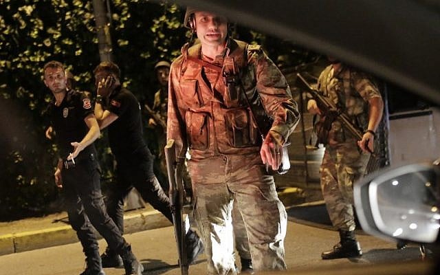 Turkish security officers detain Turkish police officers (in black) on July 15, 2016 in Istanbul, during a security shutdown of the Bosphorus Bridge. (AFP PHOTO/Yasin AKGUL) Turkish security officers detain Turkish police officers (in black) on July 15, 2016 in Istanbul, during a security shutdown of the Bosphorus Bridge. (AFP PHOTO/Yasin AKGUL)