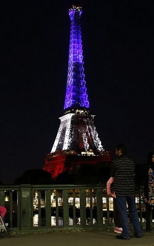 A picture taken on July 15, 2016 shows the Eiffel Tower in Paris illuminated with the colours of the French National flag in tribute for the victims of the Bastille Day attack in Nice that killed 84 people. (AFP PHOTO/MATTHIEU ALEXANDRE)