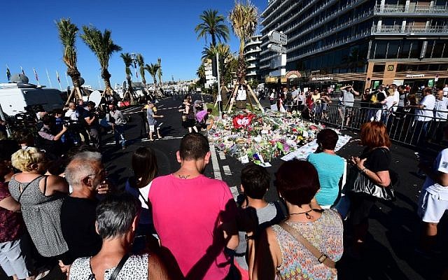 People lay flowers, candles and messages at a makeshift memorial in Nice on July 16, 2016, in tribute to the victims of the Bastille Day attack on the Promenade des Anglais seafront which killed 84 people. (AFP PHOTO/GIUSEPPE CACACE) People lay flowers, candles and messages at a makeshift memorial in Nice on July 16, 2016, in tribute to the victims of the Bastille Day attack on the Promenade des Anglais seafront which killed 84 people. (AFP PHOTO/GIUSEPPE CACACE)