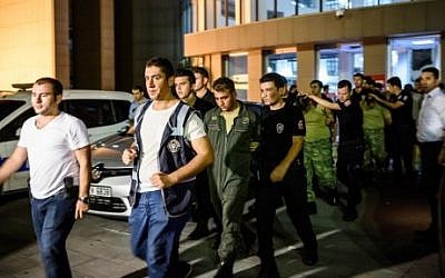 Turkish anti-riot police escort soldiers who allegedly took part in a military coup, as they leave a courthouse in Istanbul on July 16, 2016. (AFP PHOTO/OZAN KOSE)