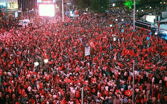 People wave flags as they gather in Kizilay Square in Ankara on July 16, 2016 during a demonstration in support of the Turkish president. President Recep Tayyip Erdogan regained control over Turkey after a coup attempt. (AFP PHOTO / ADEM ALTAN)