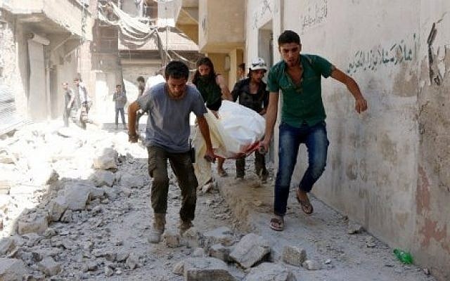 Illustrative image of Syrians evacuating a body on a stretcher following airstrikes on the rebel-controlled neighborhood of Maysar in the northern Syrian city of Aleppo, on July 17, 2016. (AFP/Thaer Mohammed) Illustrative image of Syrians evacuating a body on a stretcher following airstrikes on the rebel-controlled neighborhood of Maysar in the northern Syrian city of Aleppo, on July 17, 2016. (AFP/Thaer Mohammed)