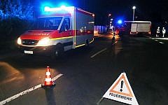 Rescuers gather on a road near railtracks in Wuerzburg southern Germany on July 18, 2016 after a man attacked train passengers with an ax. (AFP PHOTO / dpa / Karl-Josef Hildenbrand)