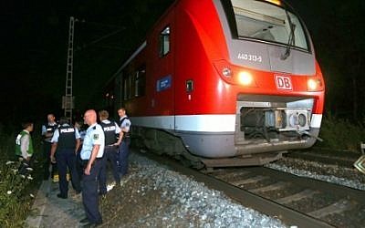 Police officers stand by a regional train in Wuerzburg southern Germany on July 18, 2016 after a man attacked train passengers with an axe. (AFP PHOTO / dpa / Karl-Josef Hildenbrand)