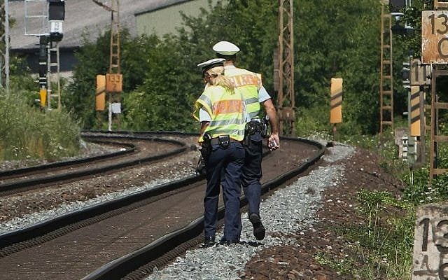 Police officers walk along train tracks in Wuerzburg southern Germany on July 19, 2016, a day after a man attacked train passengers with an ax. (AFP PHOTO / DANIEL ROLAND) Police officers walk along train tracks in Wuerzburg southern Germany on July 19, 2016, a day after a man attacked train passengers with an ax. (AFP PHOTO / DANIEL ROLAND)