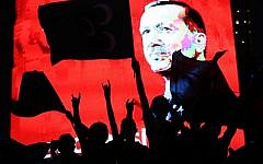 Supporters stand in front of a screen displaying a portrait of Turkish President Recep Tayyip Erdogan during a rally at Kizilay Square in Ankara on July 20, 2016. (AFP/Adem Altan)