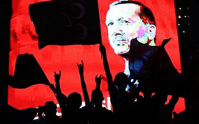 Supporters stand in front of a screen displaying a portrait of Turkish President Recep Tayyip Erdogan during a rally at Kizilay Square in Ankara on July 20, 2016. (AFP/Adem Altan)