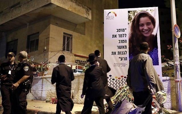 Ultra-Orthodox Jewish men walk past the site where Shira Banki, 16, was killed in July 2015 after she was attacked by Yishai Shlissel during the annual Gay Pride march in Jerusalem, July 21, 2016. (AFP Photo/Thomas Coex)