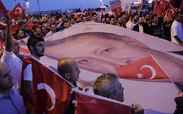 Supporters carry Turkish President Recep Tayyip Erdogan's portrait during a rally at Bosphorus bridge in Istanbul on July 21, 2016. (AFP/Yasin Akgul) Supporters carry Turkish President Recep Tayyip Erdogan's portrait during a rally at Bosphorus bridge in Istanbul on July 21, 2016. (AFP/Yasin Akgul)
