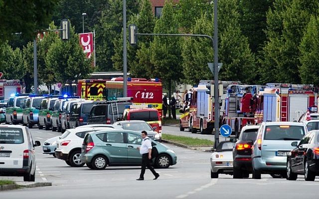 Police and firefighters are seen near a shopping mall amid a shooting on July 22, 2016 in Munich. (AFP PHOTO / dpa / Matthias Balk)