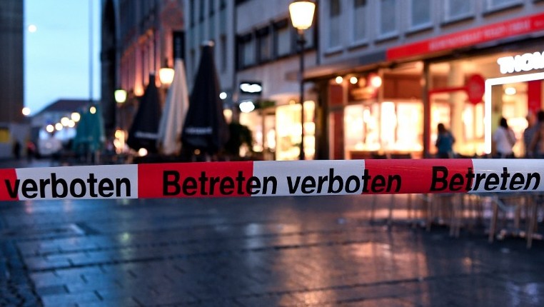 Police sign blocks the entrance to Odeon square following shootings at a shopping mall earlier on July 22, 2016 in Munich. (AFP PHOTO / dpa / Sven Hoppe) Police sign blocks the entrance to Odeon square following shootings at a shopping mall earlier on July 22, 2016 in Munich. (AFP PHOTO / dpa / Sven Hoppe)