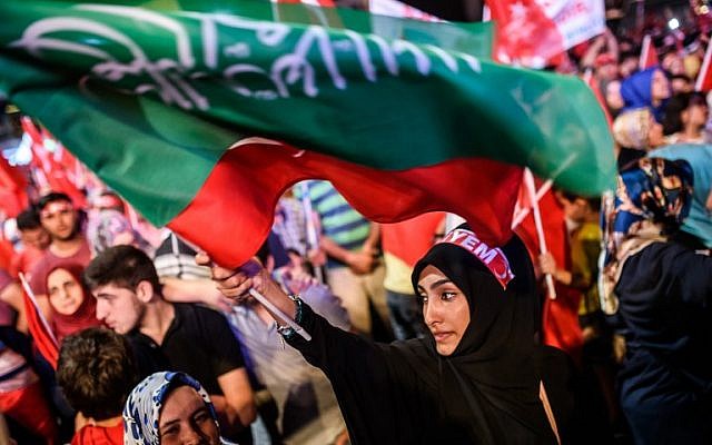 A woman waves flags during a pro-Erdogan rally in Taksim square in Istanbul on July 22, 2016, following the failed military coup attempt of July 15. (AFP PHOTO/OZAN KOSE)