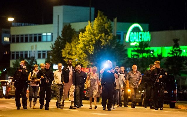 People are evacuated from the area around the shopping mall Olympia Einkaufzentrum OEZ in Munich on July 22, 2016 after a German-Iranian gunman  went on a shooting rampage in the busy shopping center, killing nine people. (AFP PHOTO/STRINGER)