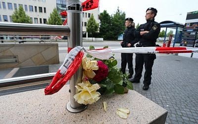 Police officers stand at the entrance of the subway station near the shopping mall Olympia Einkaufzentrum OEZ in Munich on July 23, 2016 a day after a gunman  went on a shooting rampage in the busy shopping center, killing nine people. (AFP PHOTO/DPA/Karl-Josef Hildenbrand)