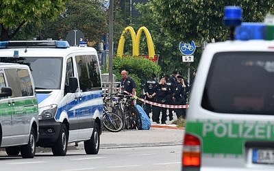 Police officers secure the area around a McDonald's restaurant near the shopping mall Olympia Einkaufzentrum OEZ in Munich on July 23, 2016, a day after a gunman went on a shooting rampage, killing nine people in a suspected terror attack. (AFP PHOTO/Christof Stache) Police officers secure the area around a McDonald's restaurant near the shopping mall Olympia Einkaufzentrum OEZ in Munich on July 23, 2016, a day after a gunman went on a shooting rampage, killing nine people in a suspected terror attack. (AFP PHOTO/Christof Stache)