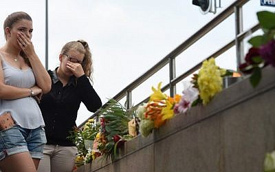Two young women mourn at an underground station near the Olympia-Einkaufszentrum shopping center on July 23, 2016, one day after a shooting attack at the shopping center in Munich killed nine people. (AFP/ Christof Stache) Two young women mourn at an underground station near the Olympia-Einkaufszentrum shopping center on July 23, 2016, one day after a shooting attack at the shopping center in Munich killed nine people. (AFP/ Christof Stache)