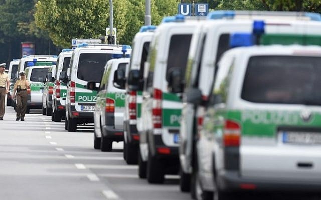 Police cars are parked near the Olympia-Einkaufszentrum shopping center on July 23, 2016, one day after a German-Iranian shooter killed nine people at the shopping center in Munich, southern Germany. (AFP/ Christof Stache)