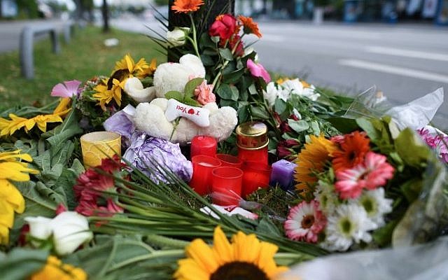 Candles and flowers are placed on July 23, 2016 in Munich, southern Germany, near the scene of a shooting, one day after the attack at the shopping center in the Bavarian capital in which nine people were killed. (AFP/ dpa / Sven Hoppe)