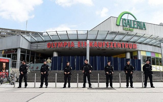 Policemen stand in front of the Olympia-Einkaufszentrum shopping center on July 23, 2016 in Munich, southern Germany, one day after a teenage German-Iranian gunman killed nine people and wounded 16. (AFP/ Christof Stache)