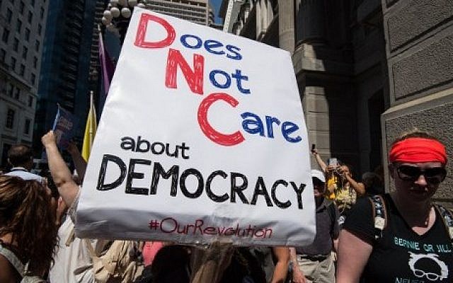 Supporters of former US Democratic presidential candidate Bernie Sanders hold signs at a rally at City Hall in Philadelphia on July 25, 2016, as Dems gather to formally declare Hillary Clinton their candidate for the November presidential election at the Democratic National Convention. (AFP/Nicholas Kamm)