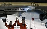 Bertrand Piccard (L) and Andre Borschberg (R), pilots of the solar powered Solar Impulse 2 aircraft, are greeted upon Piccard's arrival at Al Batin Airport in Abu Dhabi to complete its world tour flight on July 26, 2016 in the United Arab Emirates. (AFP PHOTO / KARIM SAHIB)