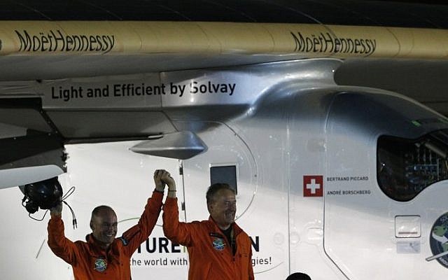 Bertrand Piccard (L) and Andre Borschberg (R), pilots of the solar powered Solar Impulse 2 aircraft, are greeted upon Piccard's arrival at Al Batin Airport in Abu Dhabi to complete its world tour flight on July 26, 2016 in the United Arab Emirates. (AFP PHOTO / KARIM SAHIB) Bertrand Piccard (L) and Andre Borschberg (R), pilots of the solar powered Solar Impulse 2 aircraft, are greeted upon Piccard's arrival at Al Batin Airport in Abu Dhabi to complete its world tour flight on July 26, 2016 in the United Arab Emirates. (AFP PHOTO / KARIM SAHIB)