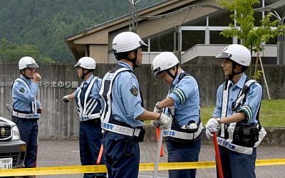Police officers guard the main gate to the Tsukui Yamayuri En care center where a knife-wielding man went on a rampage in the city of Sagamihara on July 26, 2016. (AFP PHOTO / TOSHIFUMI KITAMURA)