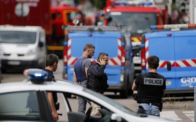 French police officers and firemen arrive at the scene of a hostage-taking at a church in Saint-Etienne-du-Rouvray, northern France, on July 26, 2016 that left the priest dead. (AFP PHOTO / CHARLY TRIBALLEAU)