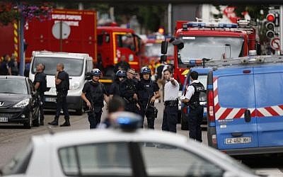French police officers and fire engine arrive at the scene of a hostage-taking at a church in Saint-Etienne-du-Rouvray, northern France, on July 26, 2016 that left the priest dead.(AFP PHOTO / CHARLY TRIBALLEAU)