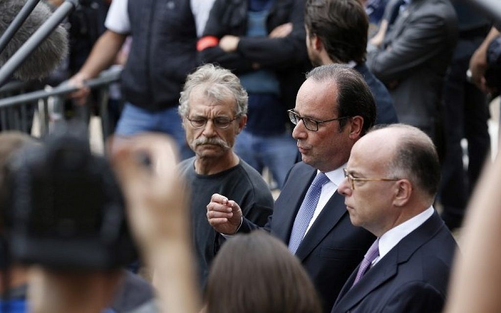 French President Francois Hollande (C) flanked by Hubert Wulfranc mayor of Saint-Etienne-du-Rouvray (L) and French Interior Minister Bernard Cazeneuve (R), speaks to the press as he leaves the Saint-Etienne-du-Rouvray's city hall following a hostage-taking at a church of the town on July 26, 2016 left a priest dead. (AFP PHOTO/CHARLY TRIBALLEAU)