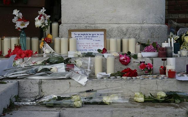 Flowers, candles and messages laid in front of the city hall in the Normandy town of Saint-Etienne-du-Rouvray in tribute to a priest killedby the Islamic State jihadist group, July 26, 2016. (AFP Photo/Mathieu Alexandre) Flowers, candles and messages laid in front of the city hall in the Normandy town of Saint-Etienne-du-Rouvray in tribute to a priest killedby the Islamic State jihadist group, July 26, 2016. (AFP Photo/Mathieu Alexandre)