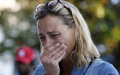 A woman mourns in front of the city hall in the Normandy city of Saint-Etienne-du-Rouvray, July 26, 2016. (AFP Photo/Mathieu Alexandre)