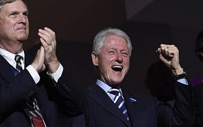 Former US president Bill Clinton, right, cheers as former New York City mayor Michael Bloomberg addresses the third evening session of the Democratic National Convention at the Wells Fargo Center in Philadelphia, Pennsylvania, July 27, 2016. (AFP/Saul Loeb)