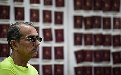 Abdullah Ghani Bhori, a Pakistani cohort of Iranian passport forger 'The Doctor' Hamid Reza Jafary (not pictured), looks on in front of fake Spanish passports at the Immigration Detention Center in Bangkok on July 22, 2016. (AFP PHOTO/LILLIAN SUWANRUMPHA) Abdullah Ghani Bhori, a Pakistani cohort of Iranian passport forger 'The Doctor' Hamid Reza Jafary (not pictured), looks on in front of fake Spanish passports at the Immigration Detention Center in Bangkok on July 22, 2016. (AFP PHOTO/LILLIAN SUWANRUMPHA)