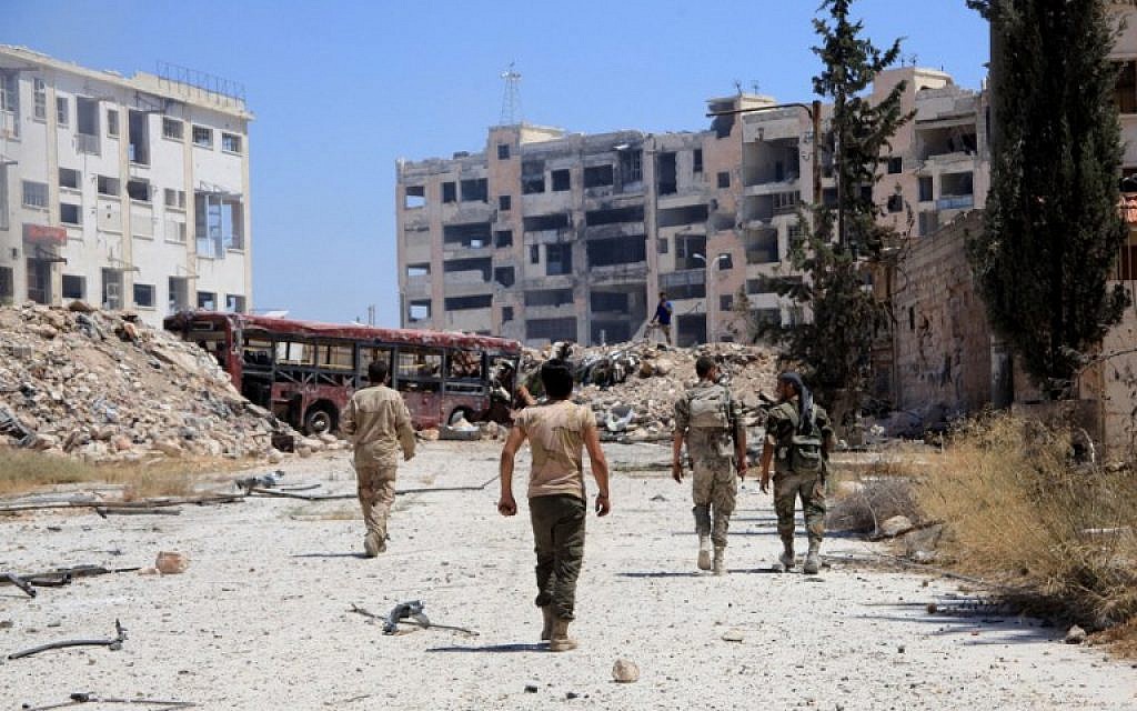 Syrian army soldiers patrol the area around the entrance of Bani Zeid after taking control of the previously rebel-held district of Leramun, on the northwest outskirts of Aleppo, on July 28, 2016. (AFP PHOTO/GEORGE OURFALIAN)