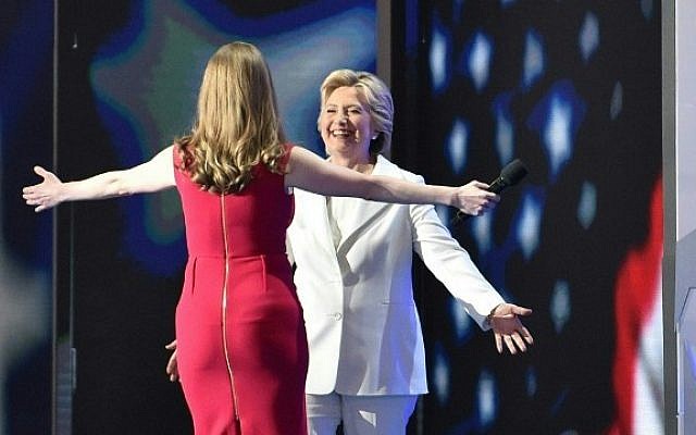 Chelsea Clinton greets Democratic presidential nominee Hillary Clinton as she arrives on stage during the fourth and final night of the Democratic National Convention at Wells Fargo Center on July 28, 2016 in Philadelphia, Pennsylvania. (AFP PHOTO / Nicholas Kamm)